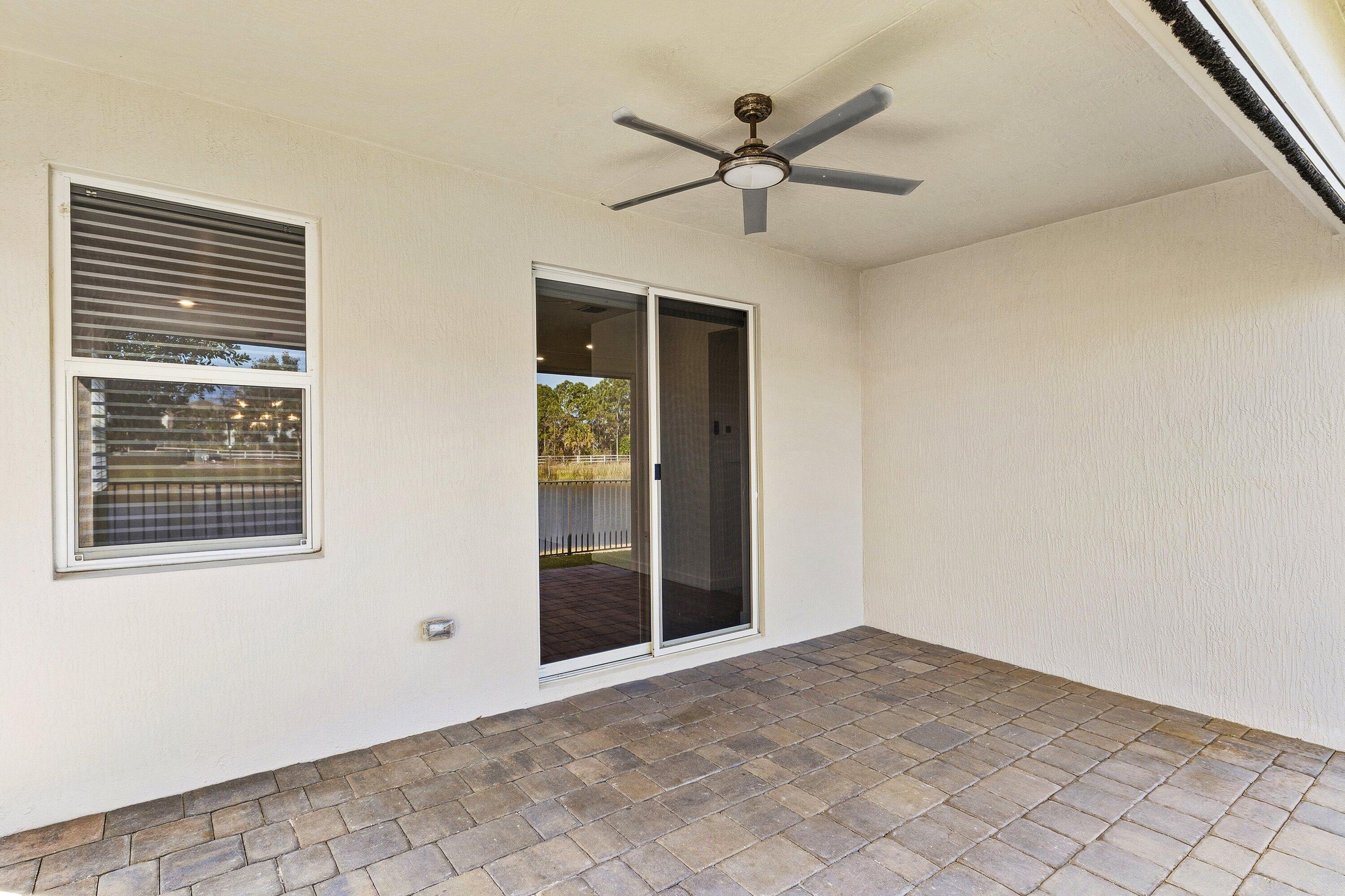 18446 Claybrook Street Jupiter, FL 33458 - Photo 19 of 25 a view of a big room with wooden floor and windows