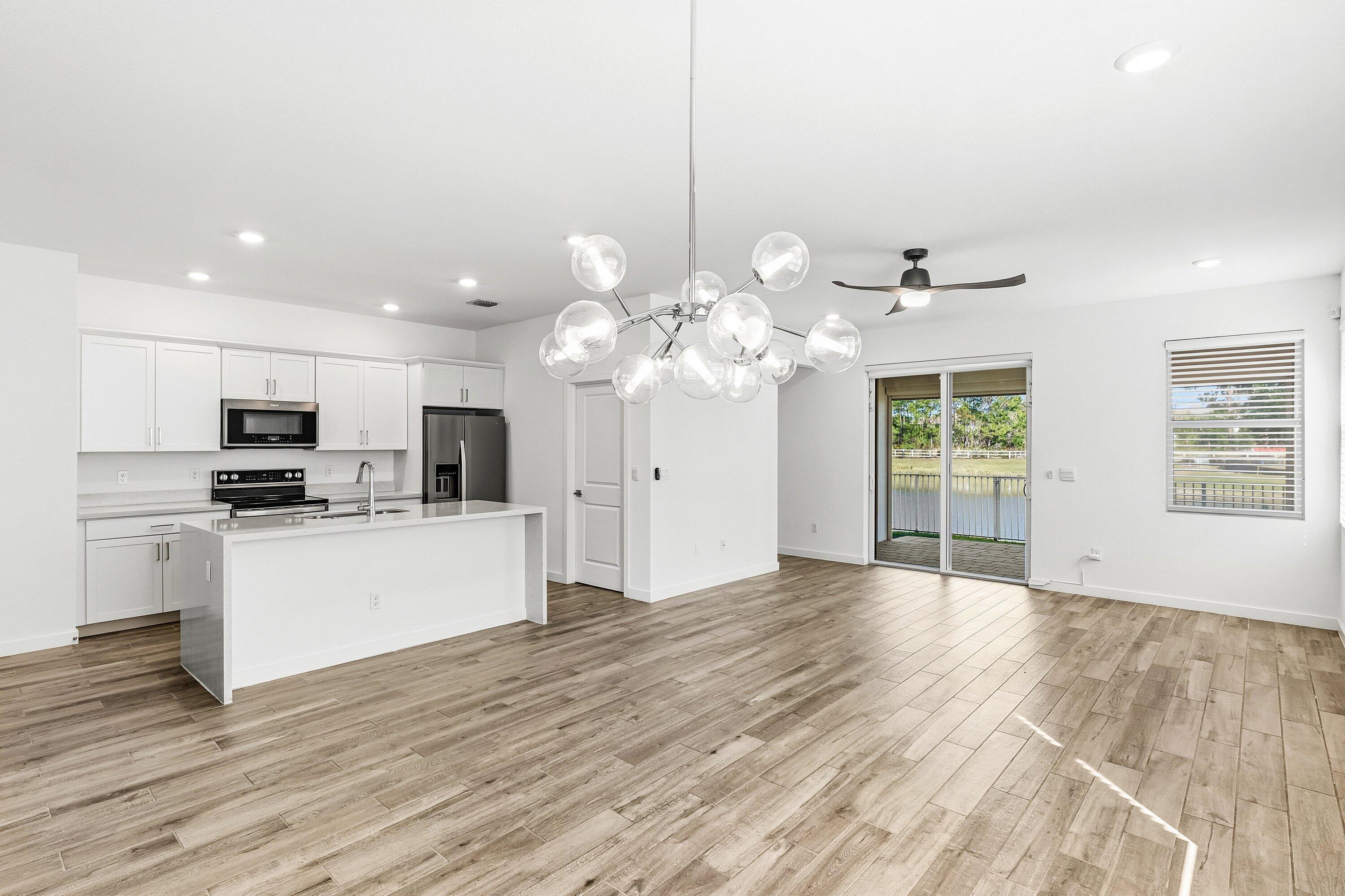 18446 Claybrook Street Jupiter, FL 33458 - Photo 2 of 25 a view of a kitchen with stove top oven and cabinets