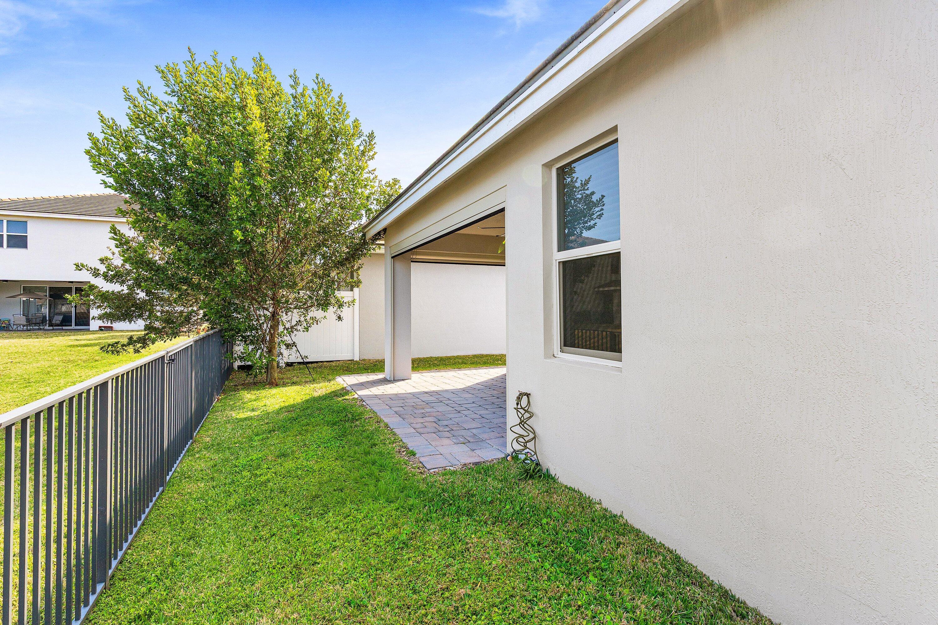 18446 Claybrook Street Jupiter, FL 33458 - Photo 21 of 25 a view of a house with backyard and tree