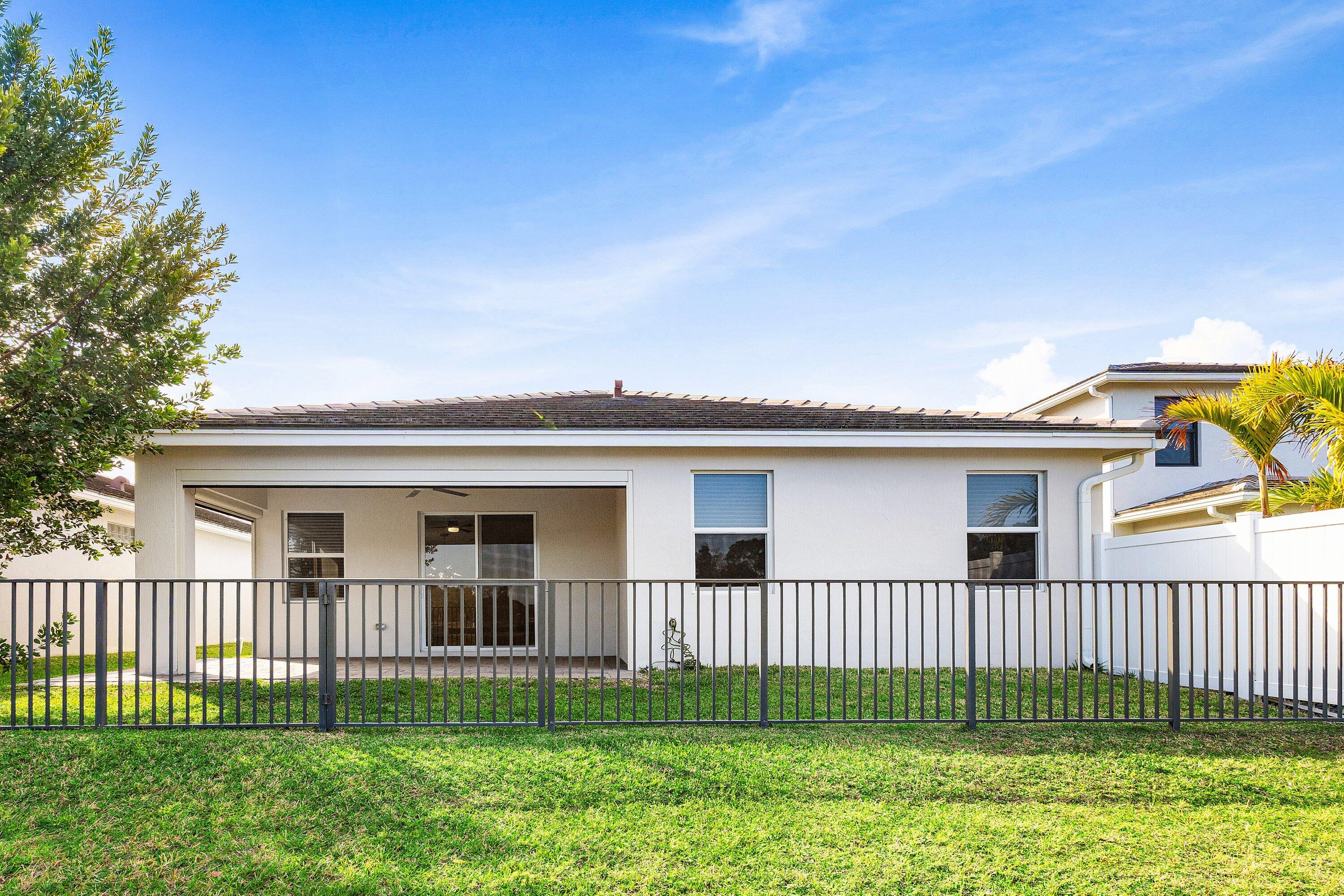 18446 Claybrook Street Jupiter, FL 33458 - Photo 25 of 25 a front view of a house with a garden