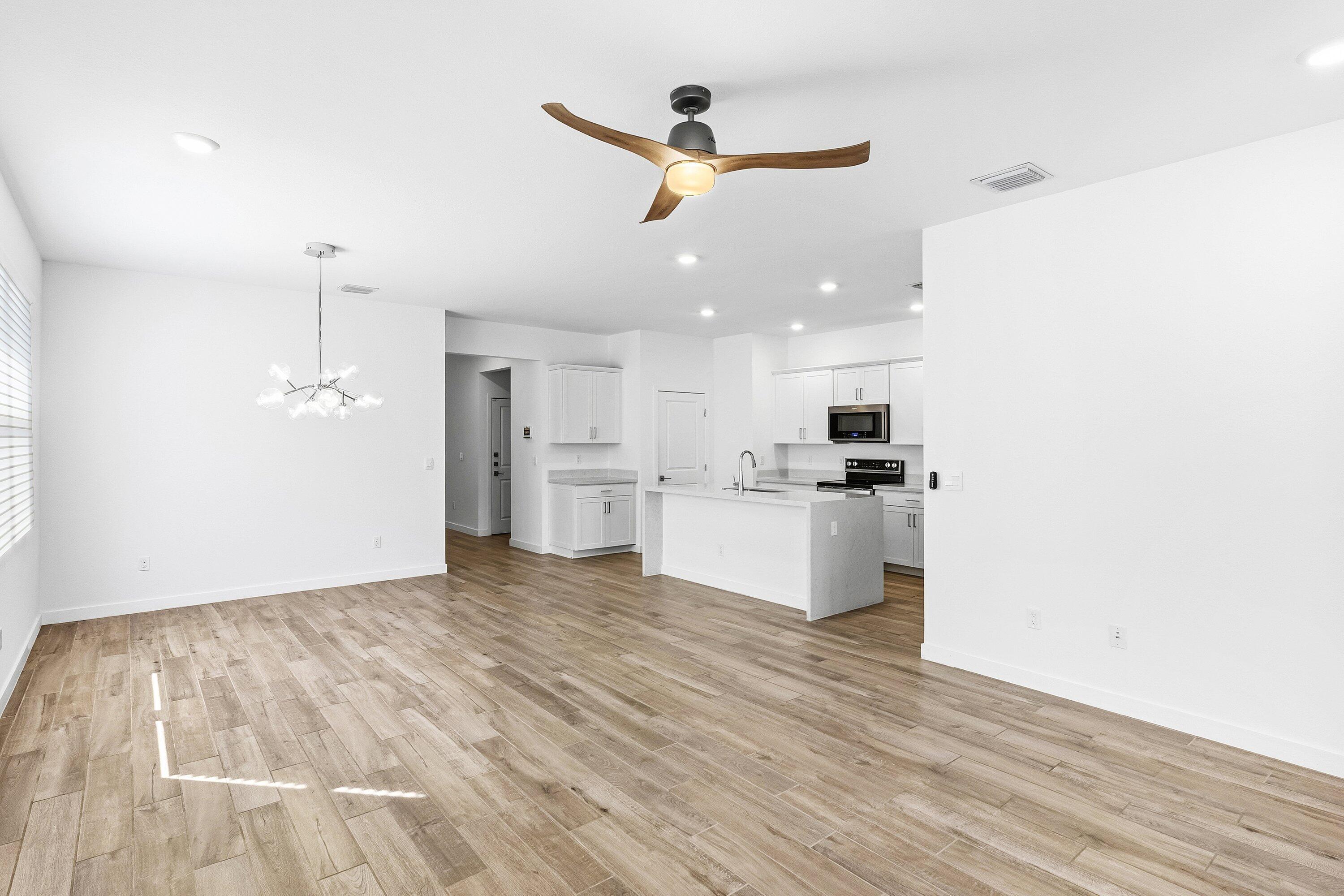 18446 Claybrook Street Jupiter, FL 33458 - Photo 3 of 25 a view of kitchen with wooden floor and window