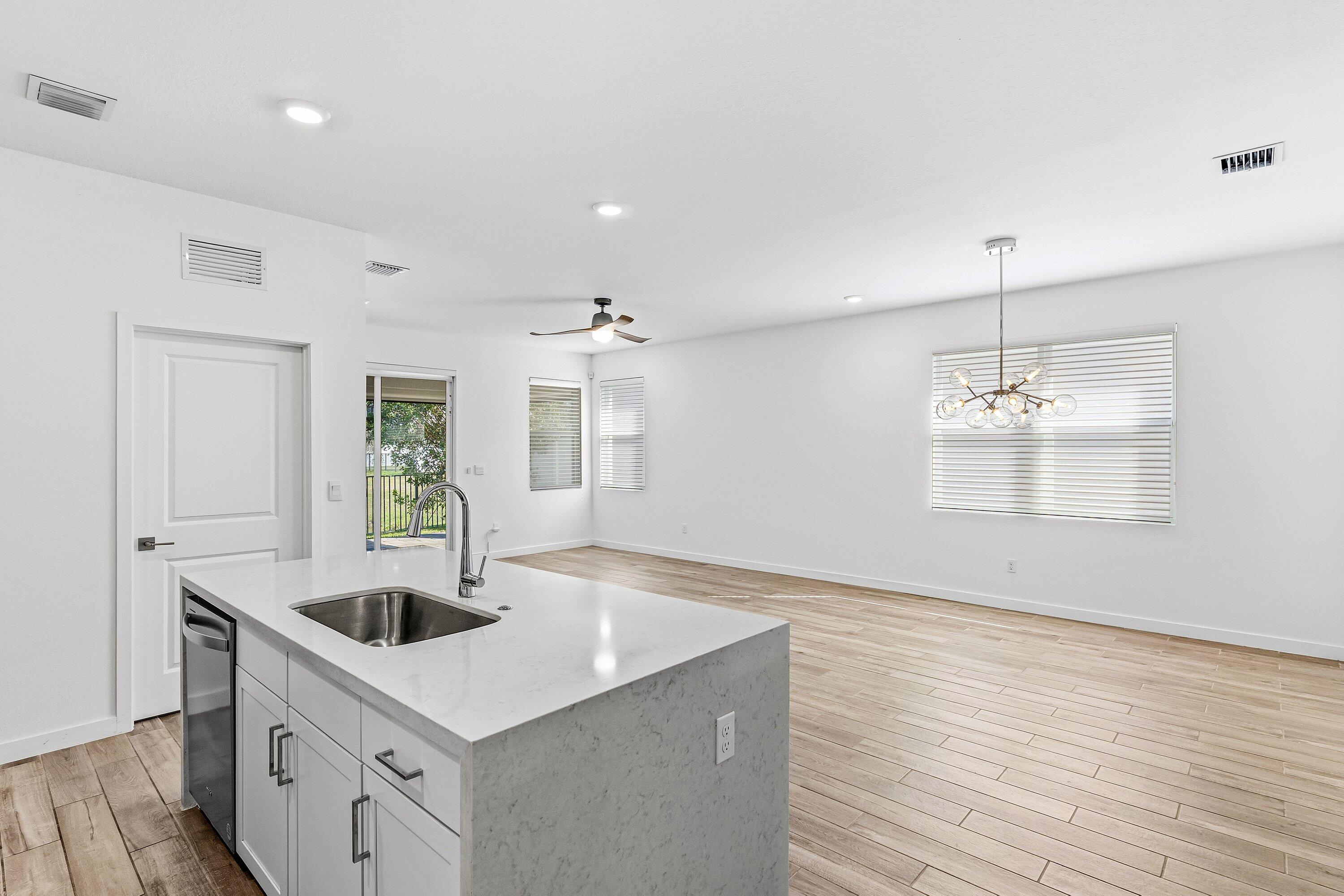 18446 Claybrook Street Jupiter, FL 33458 - Photo 7 of 25 a kitchen with a sink a refrigerator and window