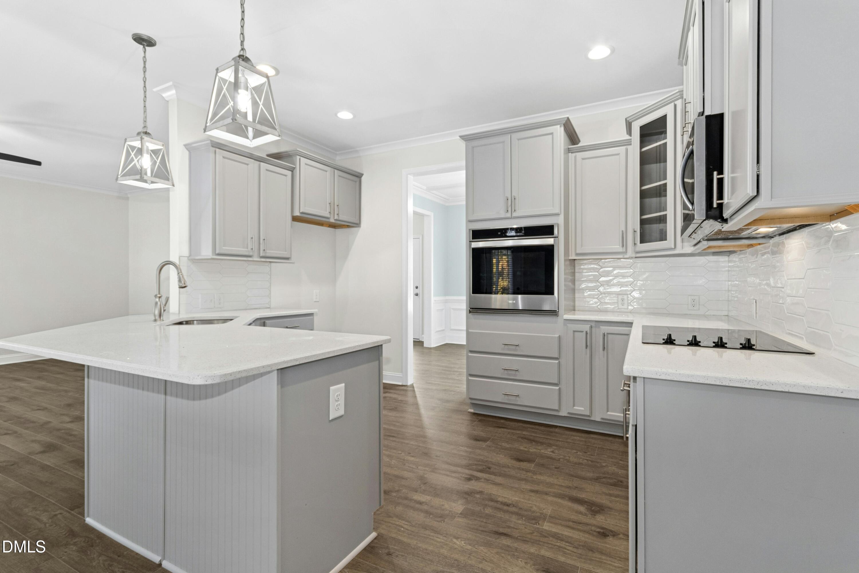 601 Joseph Alexander Drive Fuquay-Varina, NC 27526 - Photo 11 of 39 a kitchen with stainless steel appliances granite countertop a sink stove and refrigerator