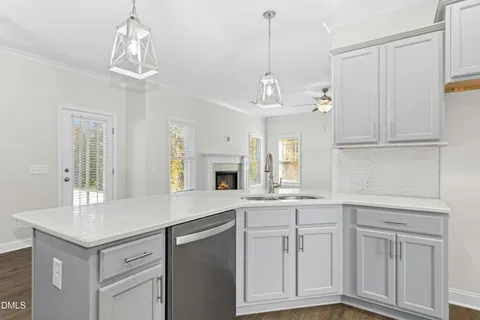 a kitchen with white cabinets and chandelier
