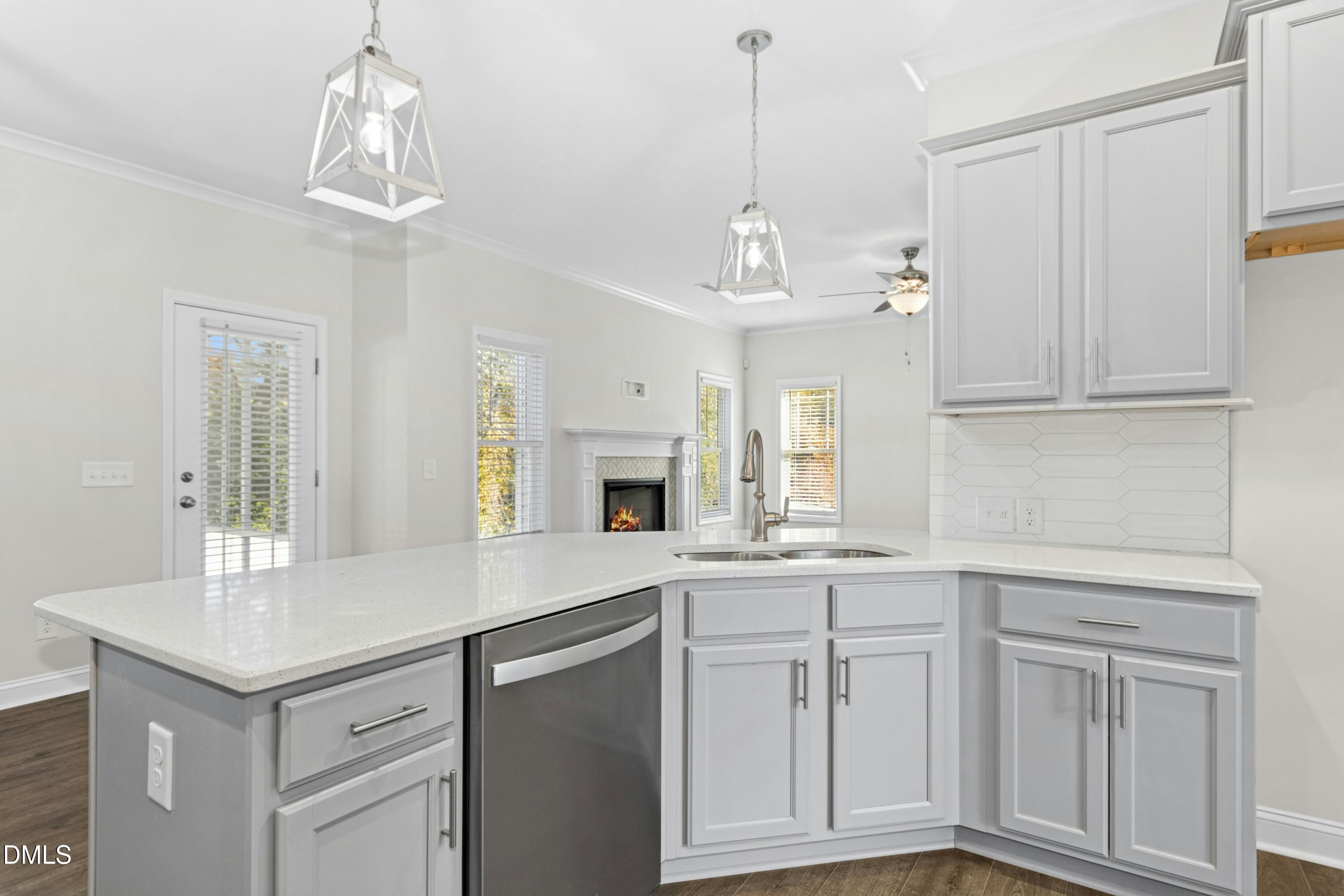 601 Joseph Alexander Drive Fuquay-Varina, NC 27526 - Photo 12 of 39 a kitchen with white cabinets and chandelier
