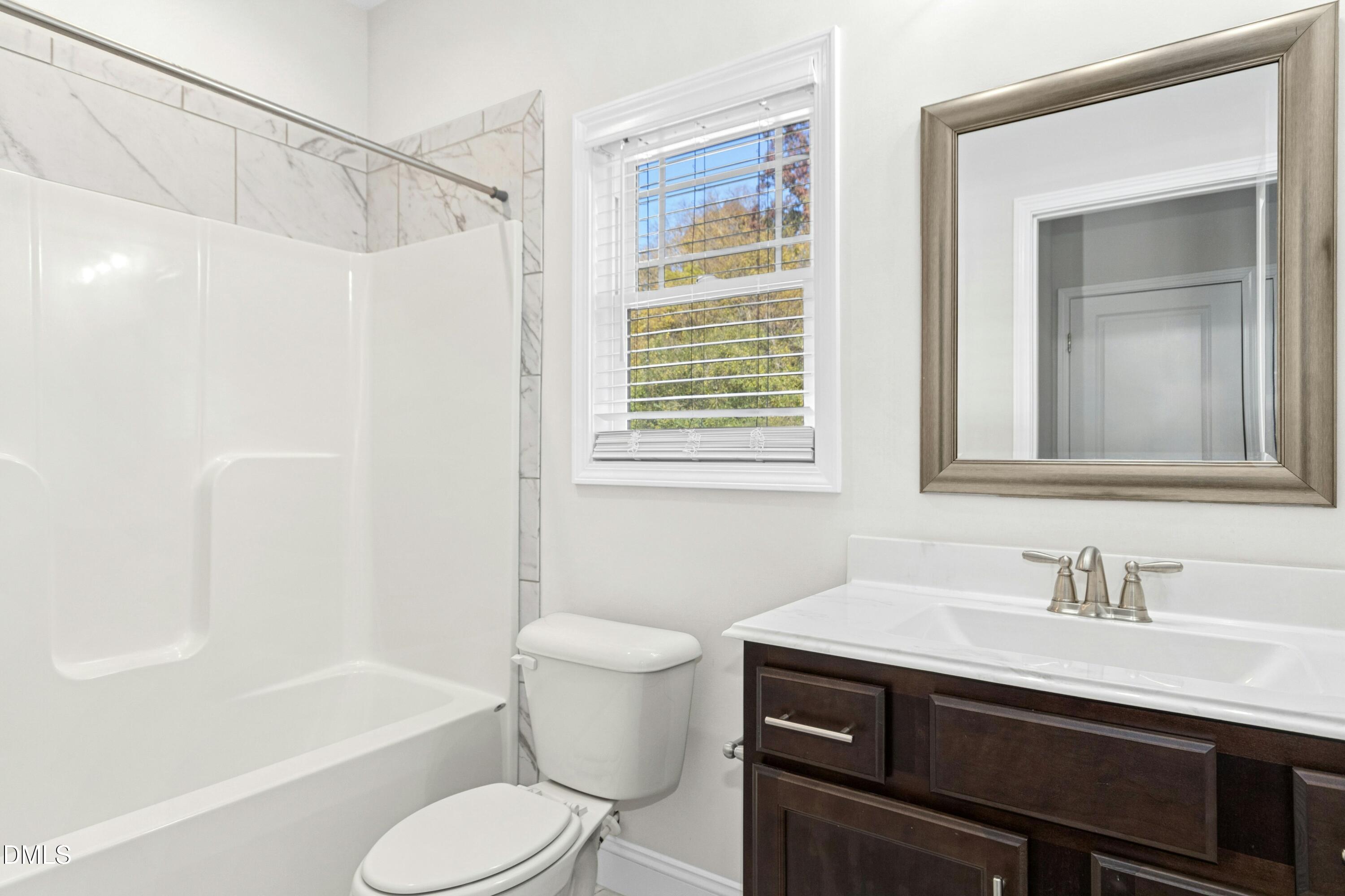 601 Joseph Alexander Drive Fuquay-Varina, NC 27526 - Photo 15 of 39 a bathroom with a sink toilet vanity and tub