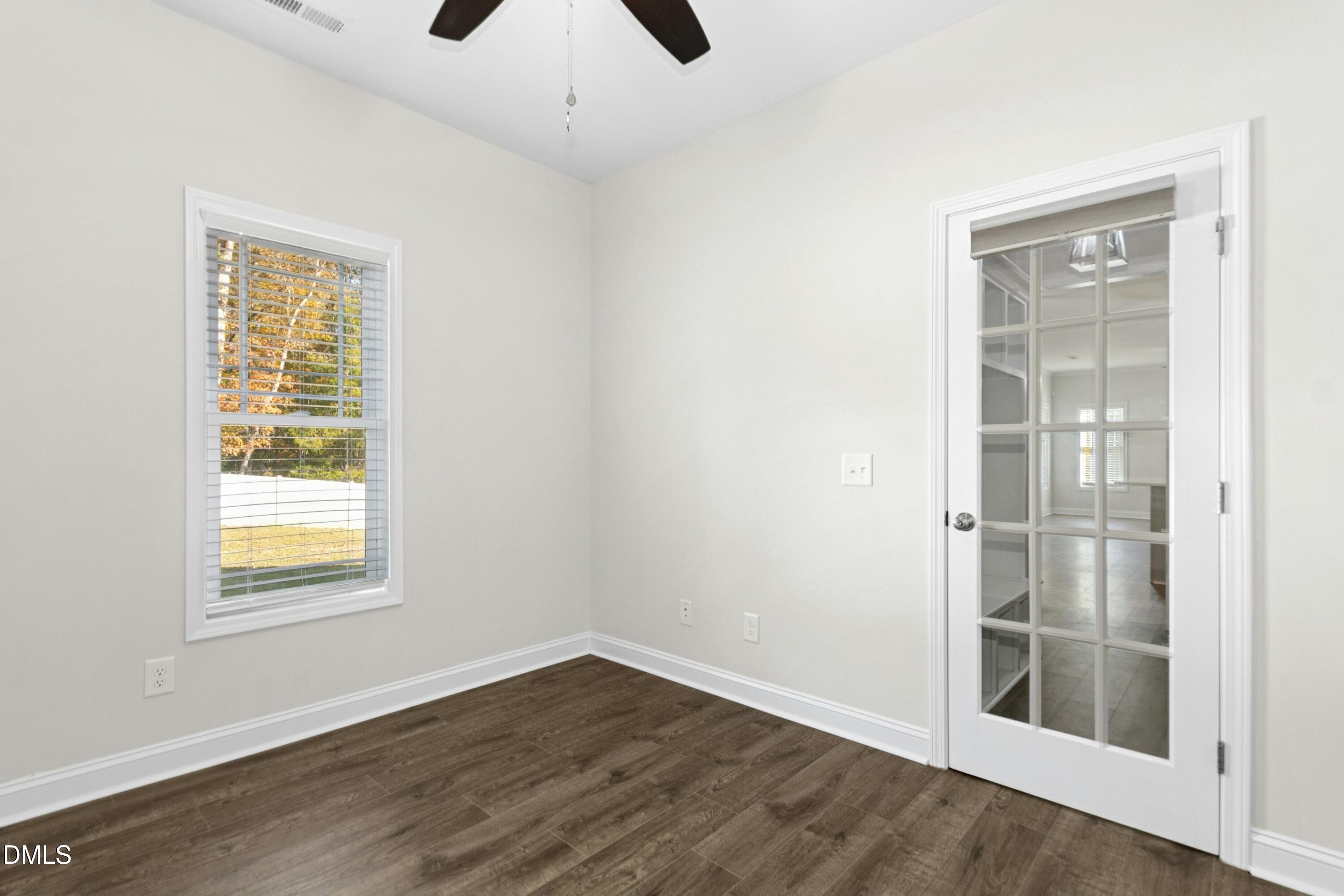 601 Joseph Alexander Drive Fuquay-Varina, NC 27526 - Photo 16 of 39 a view of an empty room with wooden floor and a window