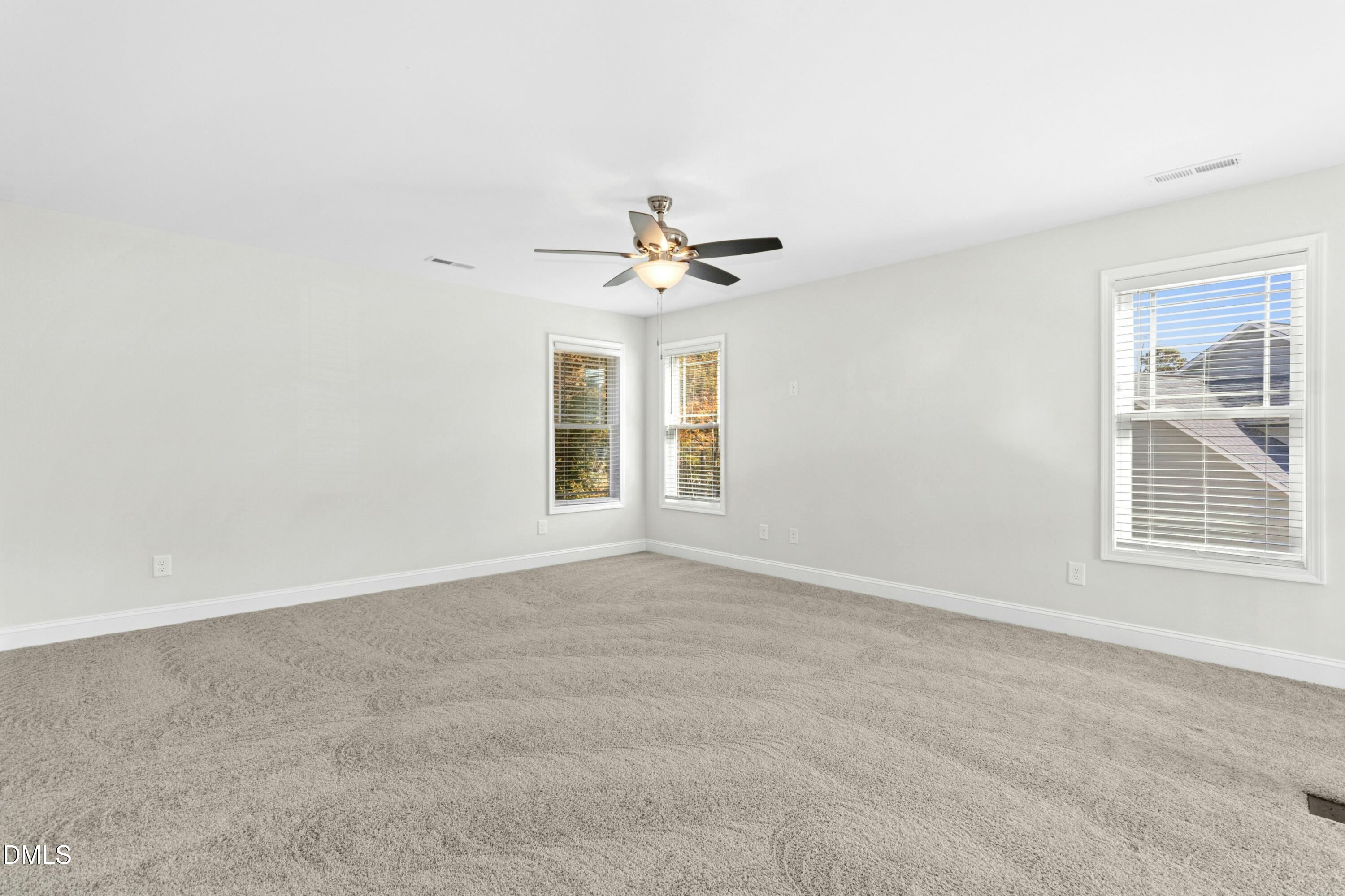 601 Joseph Alexander Drive Fuquay-Varina, NC 27526 - Photo 18 of 39 an empty room with a window and a ceiling fan