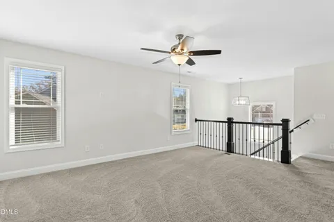 a view of a livingroom with a ceiling fan and window