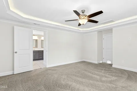 a view of an empty room with a ceiling fan