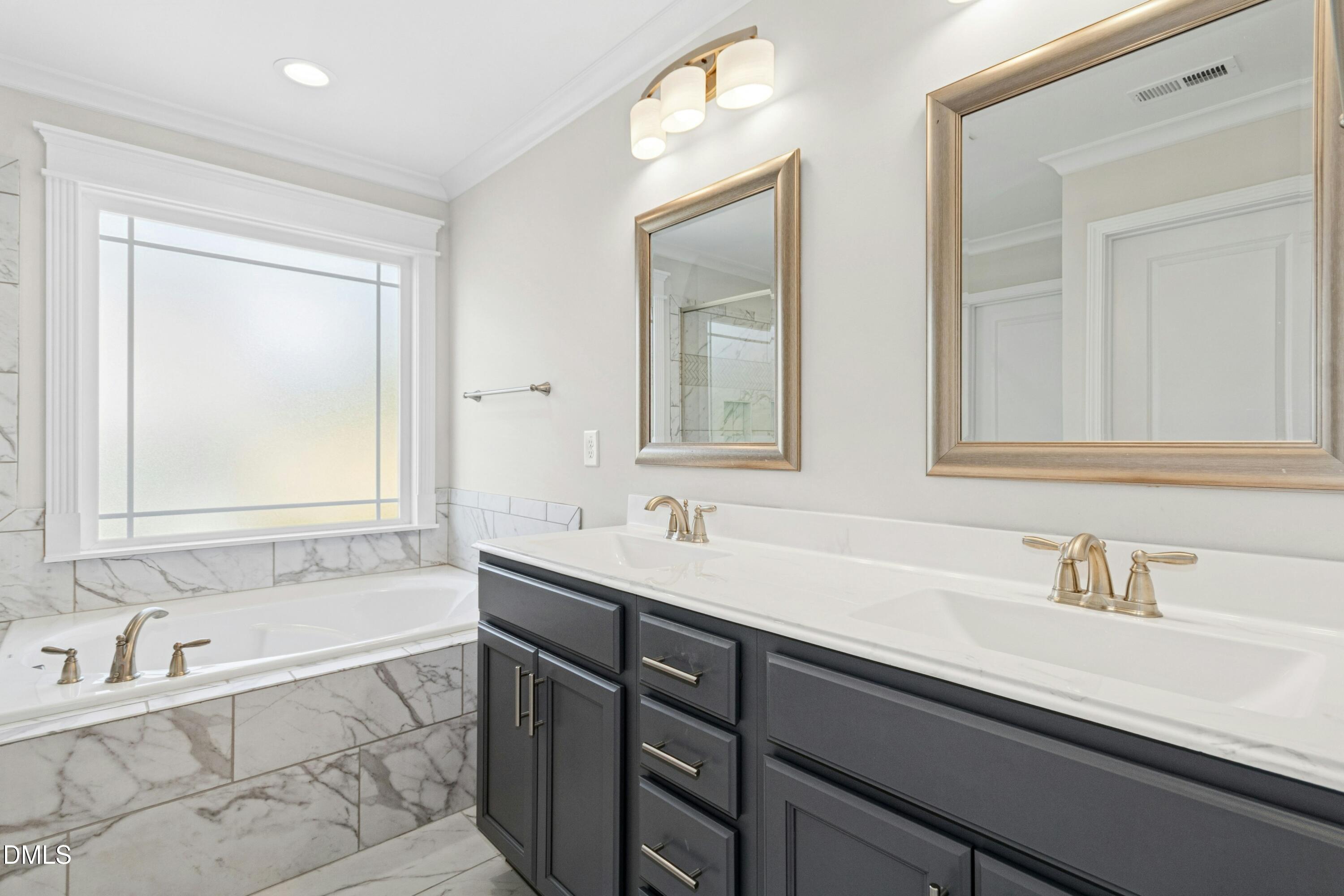 601 Joseph Alexander Drive Fuquay-Varina, NC 27526 - Photo 26 of 39 a bathroom with a sink and a bathtub