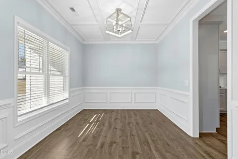 a view of a room with wooden floor and a window