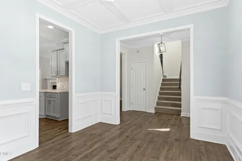 a view of a hallway with wooden floor and entryway
