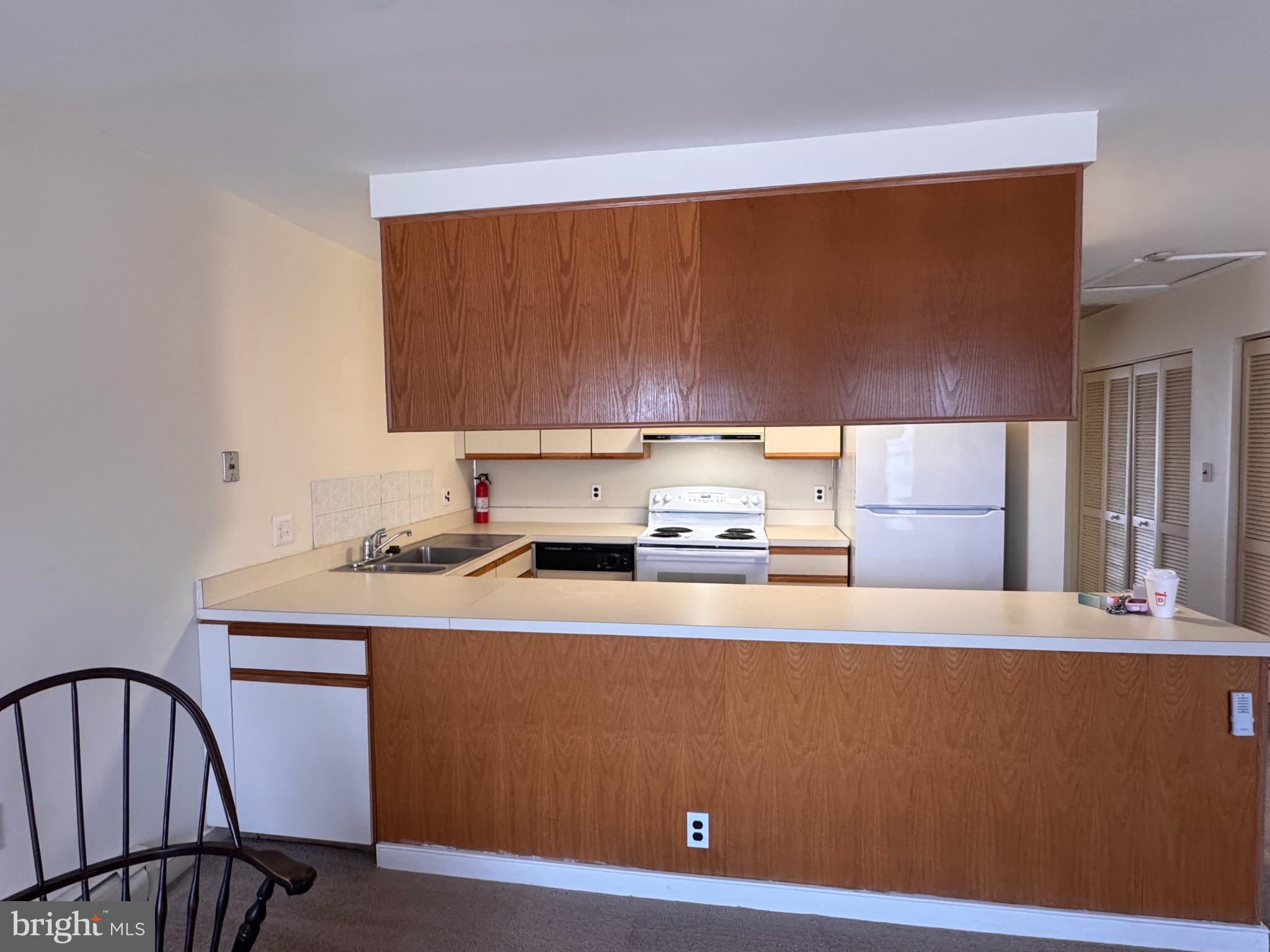 46 Buttonwood Street, Unit C Mount Holly, NJ 08060 - Photo 4 of 14 a kitchen with a sink a stove and a refrigerator