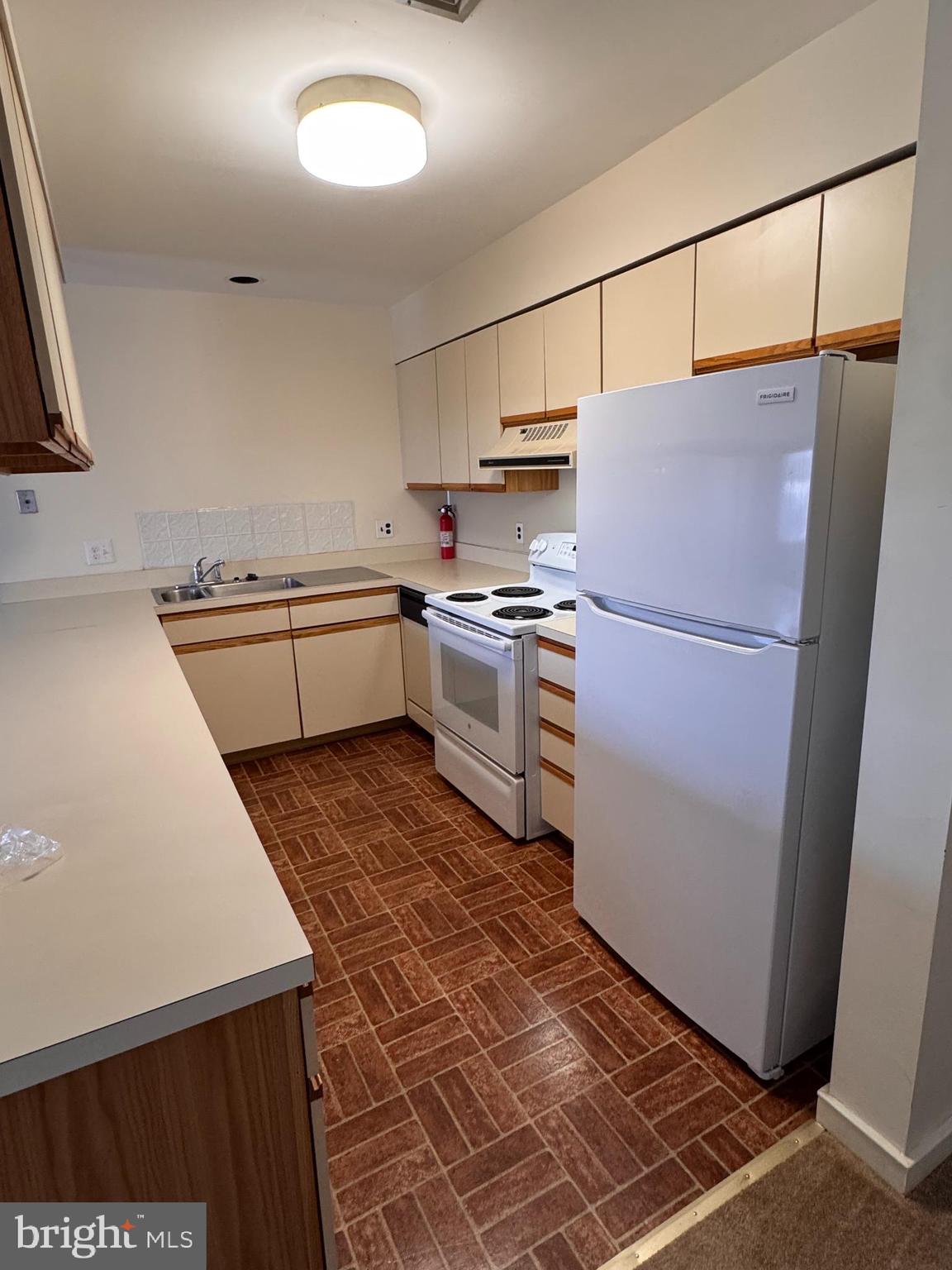 46 Buttonwood Street, Unit C Mount Holly, NJ 08060 - Photo 5 of 14 a kitchen with a refrigerator a stove top oven and a sink