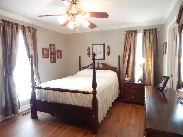 a bedroom with a bed and a chandelier