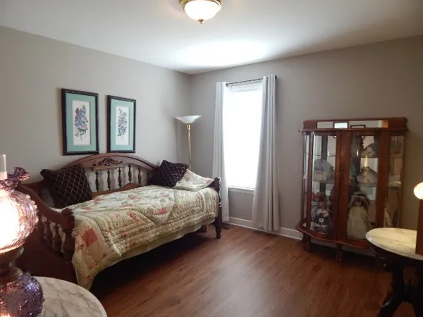 a bedroom with a bed and a night stand