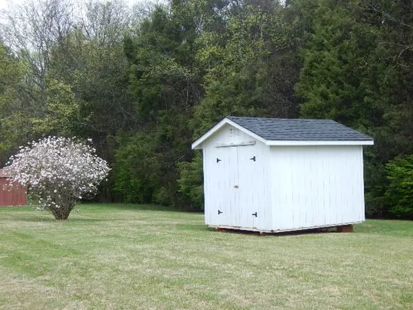 a front view of a house with a garden and porch