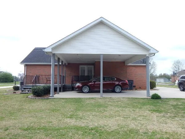 a front view of a house with a yard outdoor seating and barbeque oven