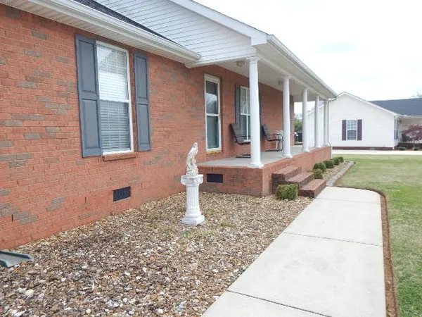 a dining room with furniture and a floor to ceiling window