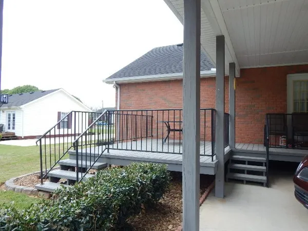 a view of a chair and table on the deck