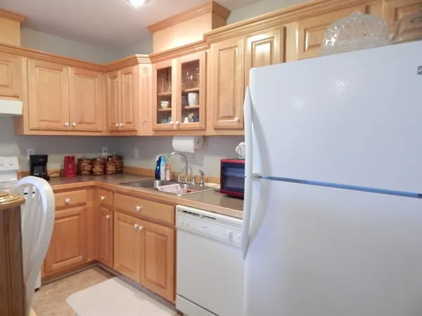 a kitchen with a refrigerator sink stove and cabinets