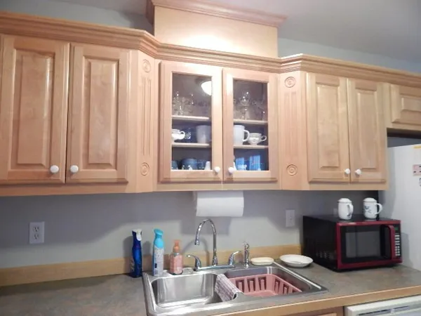 a kitchen with stainless steel appliances granite countertop a refrigerator and cabinets