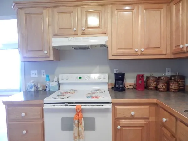 a kitchen with granite countertop cabinets and a stove