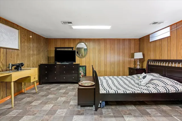 a bedroom with a bed and a television