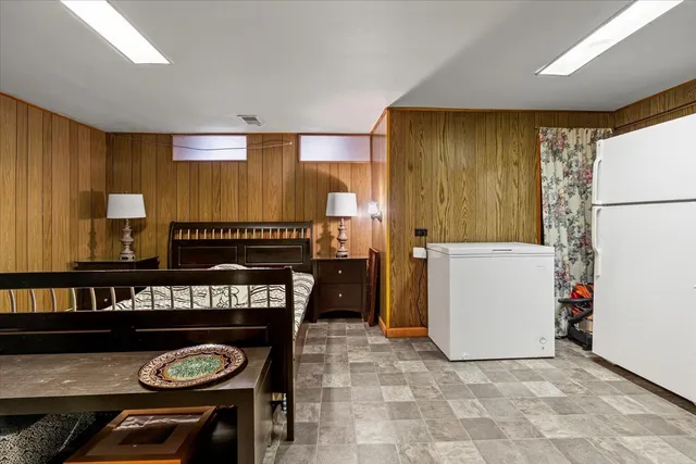 a kitchen with a refrigerator a stove a washer dryer and white cabinets