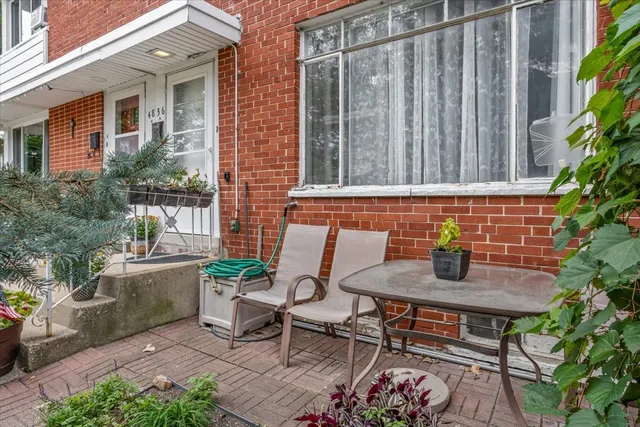 a backyard of a house with table and chairs