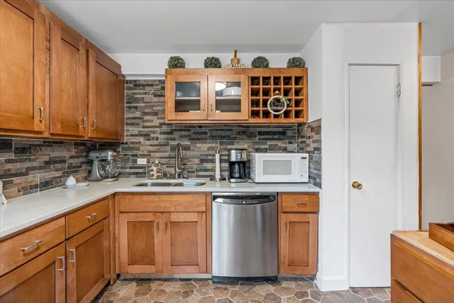 a kitchen with stainless steel appliances granite countertop a stove and cabinets