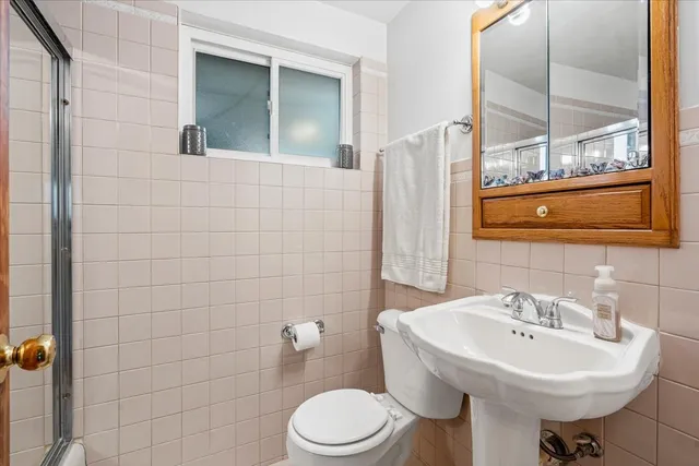 a bathroom with a sink toilet and mirror