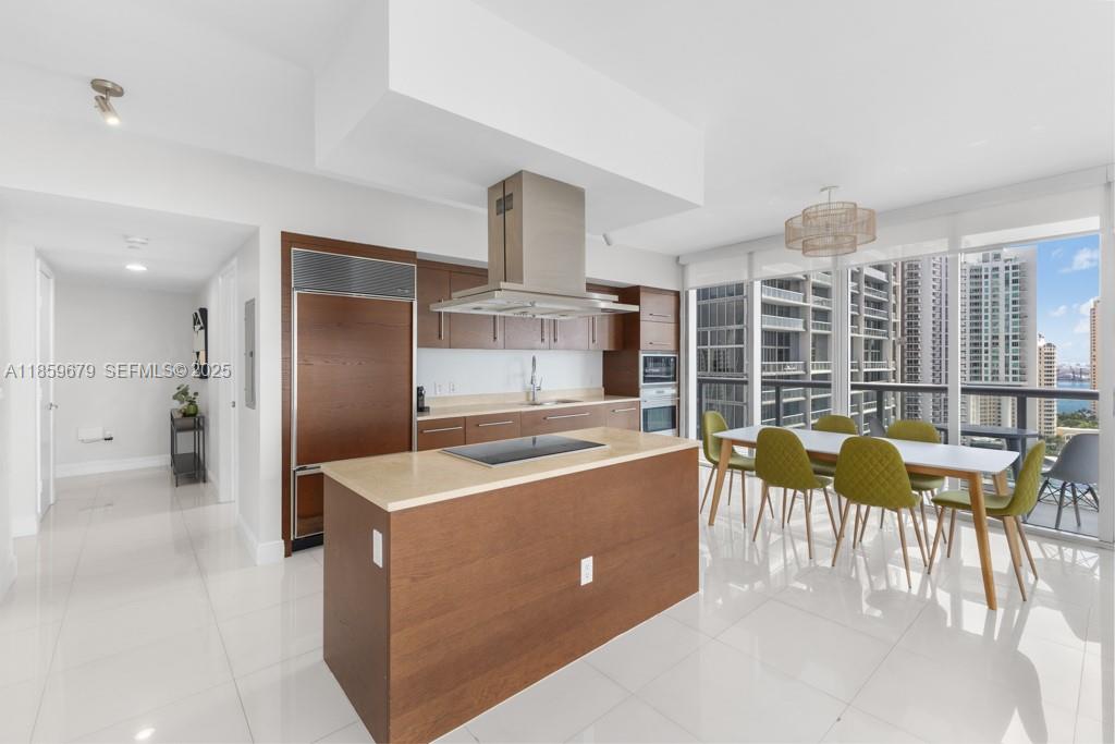 485 Brickell Avenue, Unit 2210 Miami, FL 33131 - Photo 11 of 66 a kitchen with stainless steel appliances granite countertop a table chairs and a view of living room