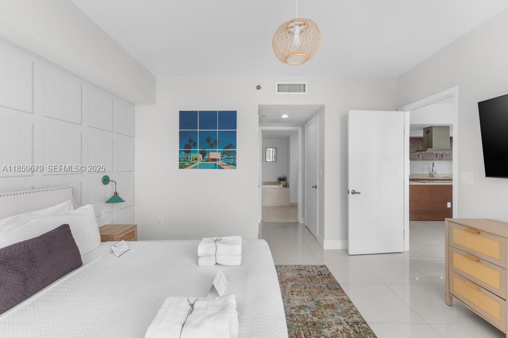 485 Brickell Avenue, Unit 2210 Miami, FL 33131 - Photo 17 of 66 a bedroom with a bed and a couch