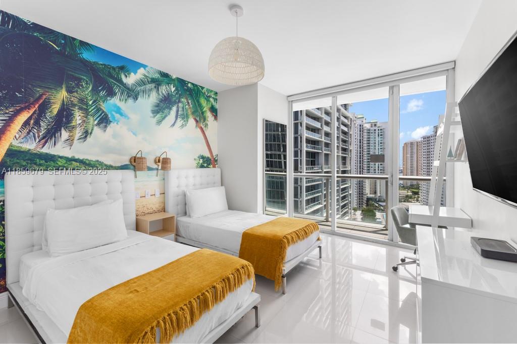 485 Brickell Avenue, Unit 2210 Miami, FL 33131 - Photo 21 of 66 a spacious bedroom with two beds and a large window