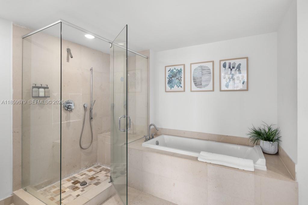 485 Brickell Avenue, Unit 2210 Miami, FL 33131 - Photo 24 of 71 a bathroom with a bathtub and shower