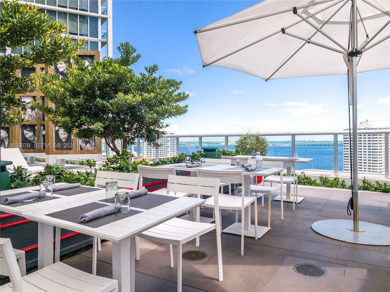 485 Brickell Avenue, Unit 2210 Miami, FL 33131 - Photo 36 of 66 a dinning table and chairs in the patio