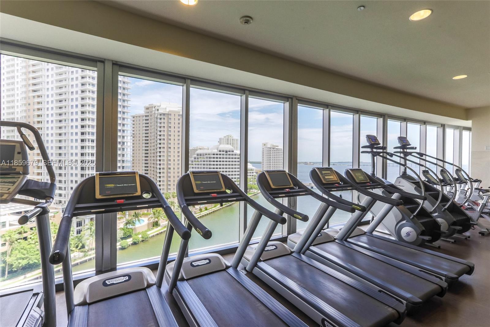 485 Brickell Avenue, Unit 2210 Miami, FL 33131 - Photo 39 of 66 a view of a dining room with furniture large windows and wooden floor