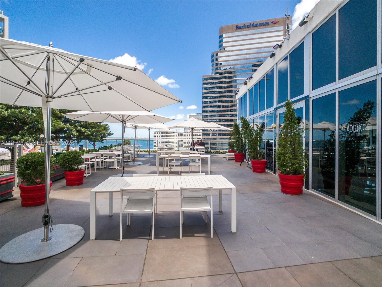 485 Brickell Avenue, Unit 2210 Miami, FL 33131 - Photo 42 of 71 a view of a patio with a table and chairs under an umbrella