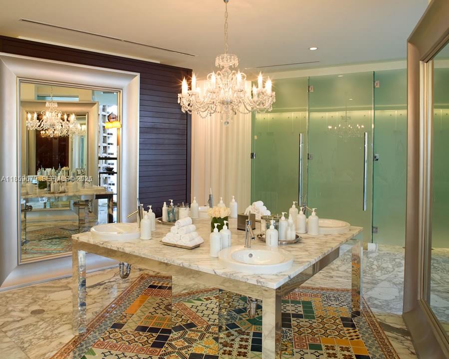485 Brickell Avenue, Unit 2210 Miami, FL 33131 - Photo 56 of 71 a view of a dining room with furniture wooden floor and chandelier