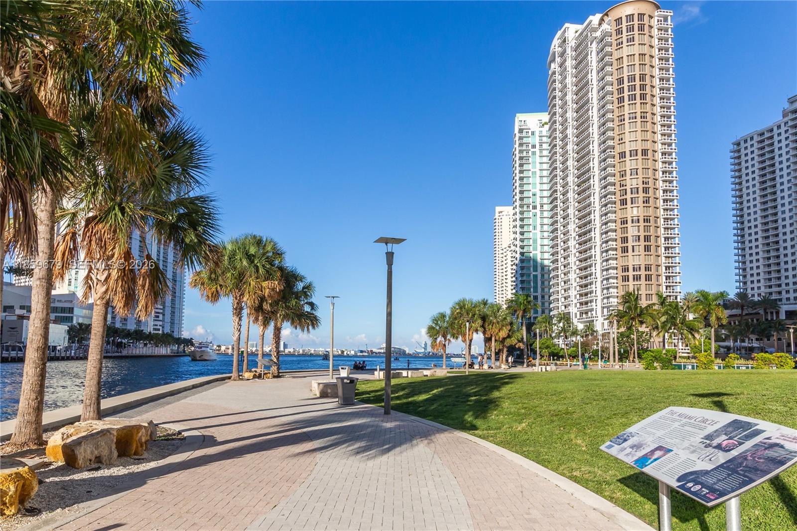 485 Brickell Avenue, Unit 2210 Miami, FL 33131 - Photo 64 of 71 a row of palm trees and a yard in front of a building