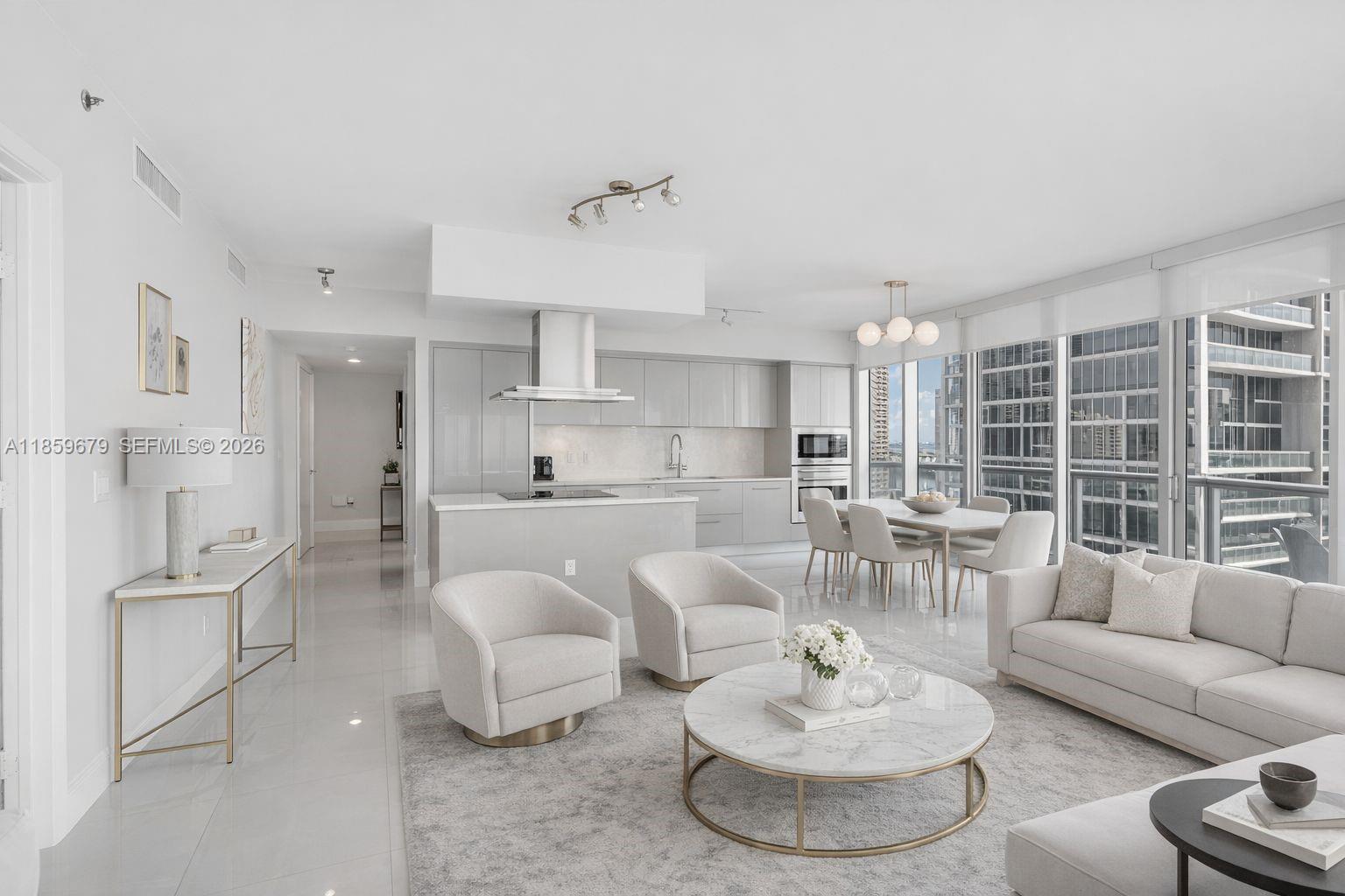 485 Brickell Avenue, Unit 2210 Miami, FL 33131 - Photo 9 of 71 a living room with furniture and a dining table with kitchen view