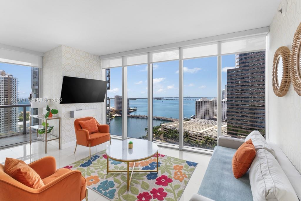 485 Brickell Avenue, Unit 2210 Miami, FL 33131 - Photo 10 of 71 a living room with furniture a flat screen tv and a large window