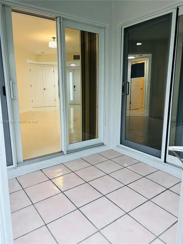 a view of a patio with table and chairs under an umbrella