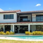 a front view of a house with lots of garden