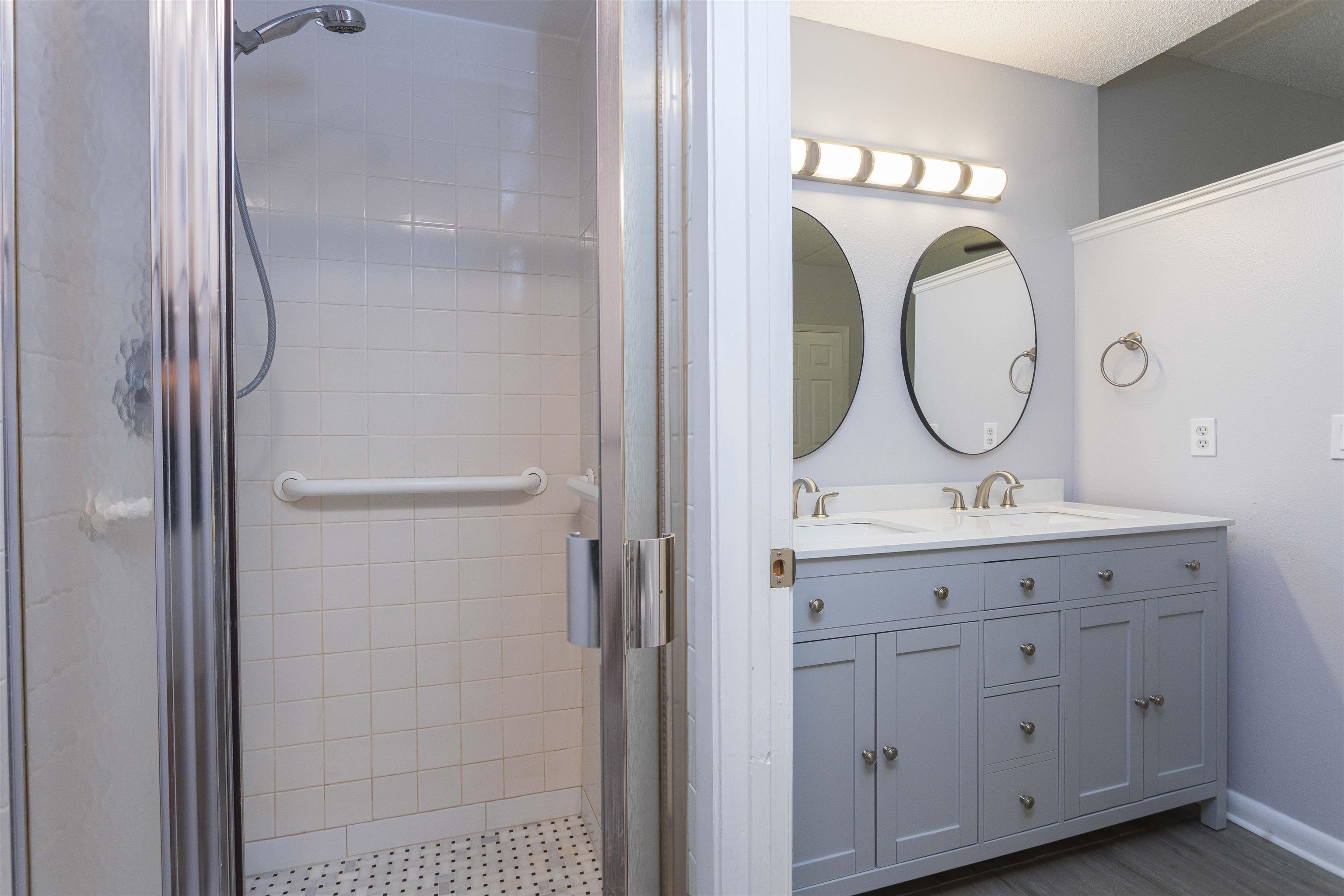 9 Aledo Court St. Augustine, FL 32086 - Photo 13 of 33 a bathroom with a granite countertop sink mirror and a shower