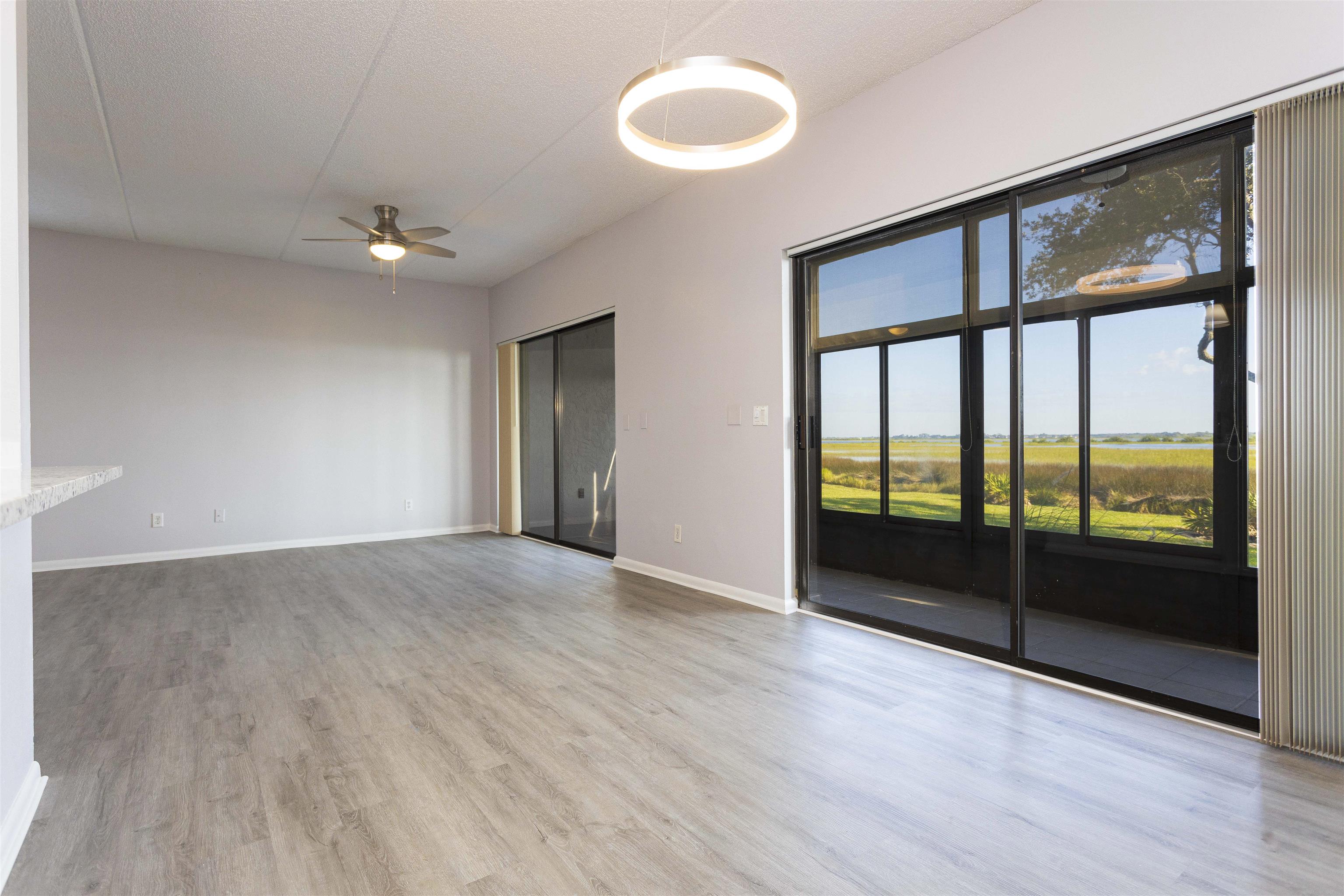 9 Aledo Court St. Augustine, FL 32086 - Photo 17 of 33 wooden floor in an empty room with a window
