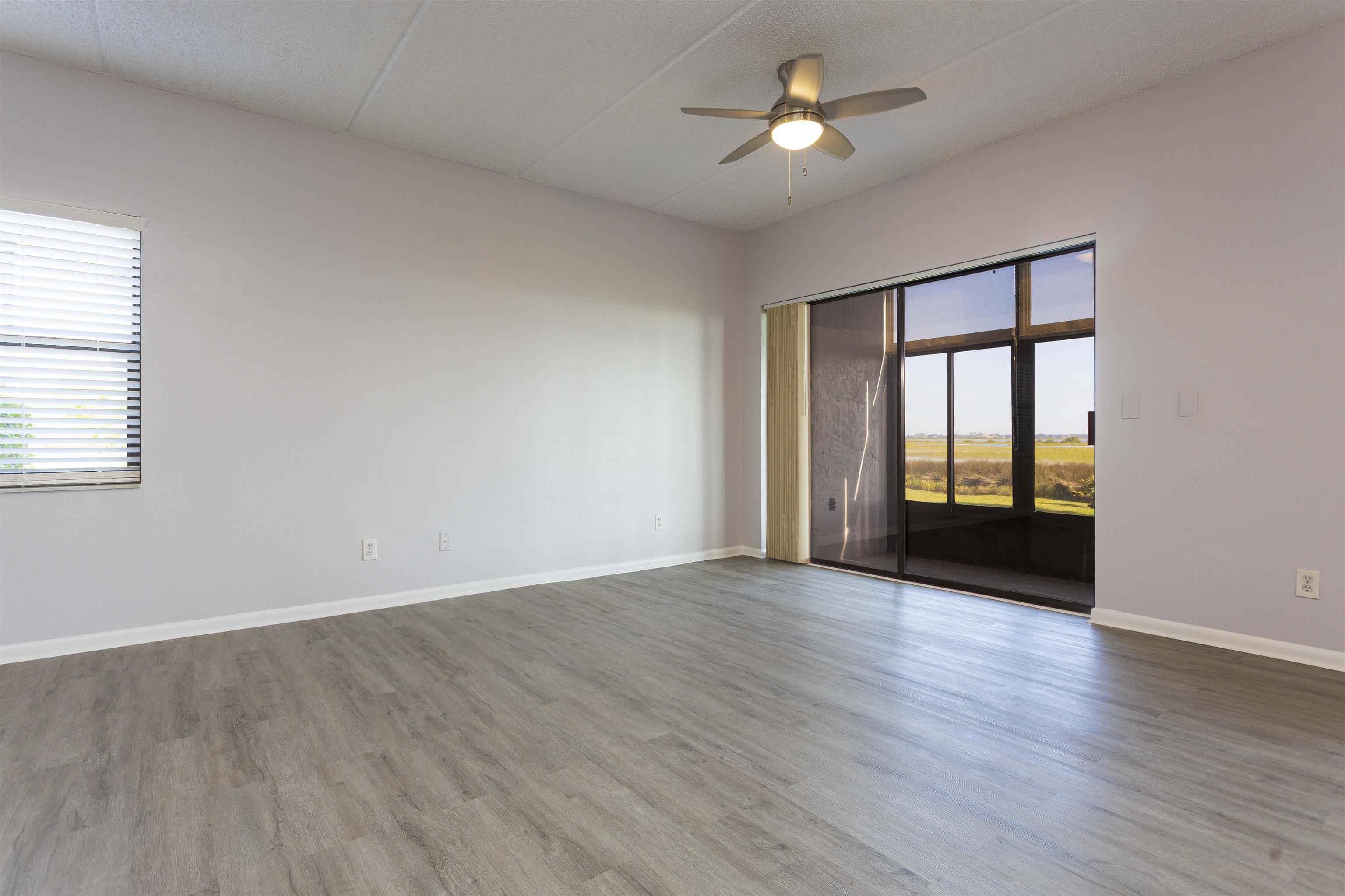 9 Aledo Court St. Augustine, FL 32086 - Photo 18 of 33 an empty room with wooden floor and windows
