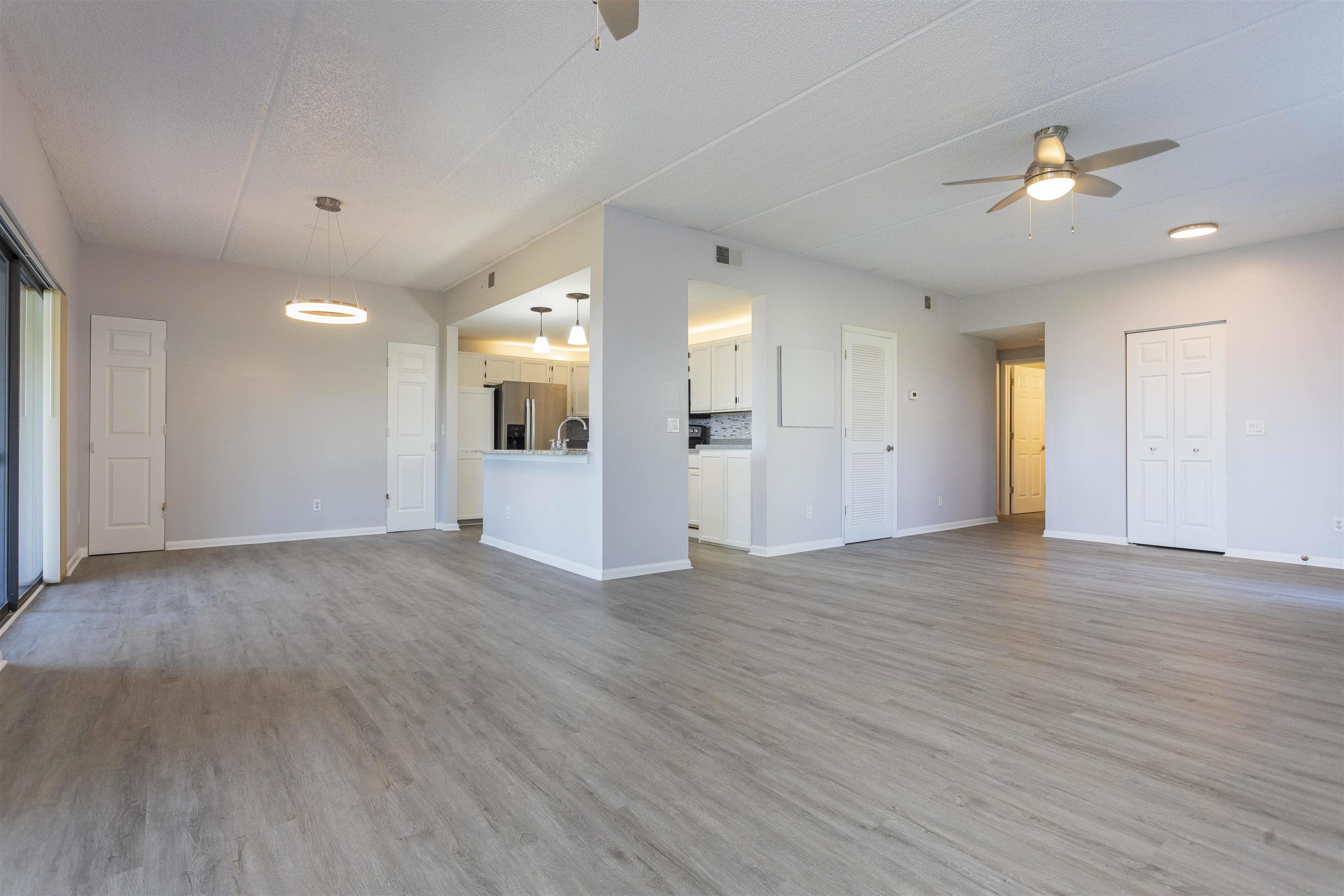 9 Aledo Court St. Augustine, FL 32086 - Photo 29 of 33 a view of an empty room with wooden floor and a kitchen